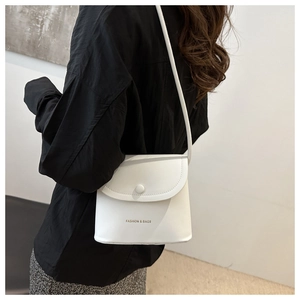 Detail of white leather crossbody bag featuring Fashion & Bags logo and gold snap closure