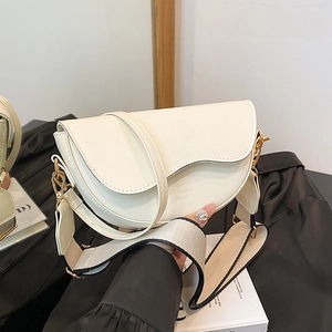 Chic beige saddle bag with gold hardware and wide adjustable shoulder strap in retro style