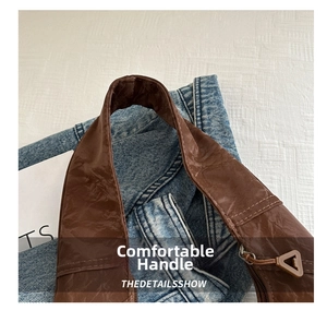 Detail of soft brown retro leather tote bag handle with fine stitching and texture