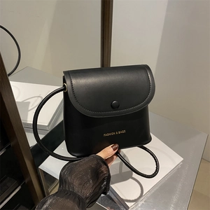 Minimalist black matte leather bucket crossbody bag with gold Fashion & Bags lettering