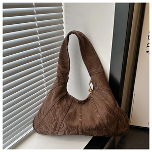 Detailed view of dark brown pleated texture fabric and triangle metal zipper pendant