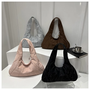 Fashionable pleated tote bags in silver, brown, pink, and black colors on display