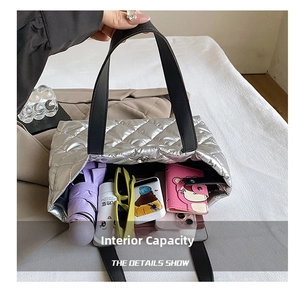 Internal capacity of quilted silver tote bag with wallet, umbrella and phone inside
