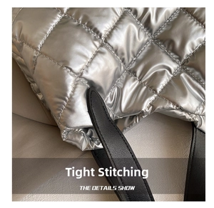 Close-up of quilted metallic silver space cotton bag with durable black leather handle