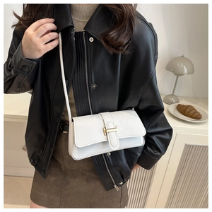 Minimalist white leather baguette bag with golden H buckle shown on a model