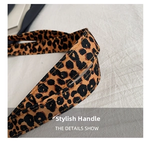 Close-up of leopard print shoulder strap with reinforced gold double stitching detail