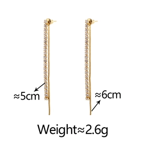 Detail view of long gold tassel earrings showing length dimensions of 5cm and 6cm