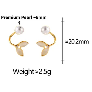 Detailed view of gold fishtail earrings with cat-eye stone, pearl, and measurements