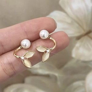 Elegant gold leaf earrings with white pearls and cat's eye stones in a forest style