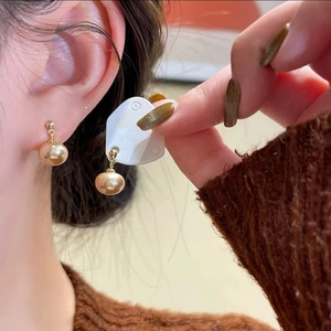 Elegant champagne gold bead tassel earrings on model for a sophisticated luxury look