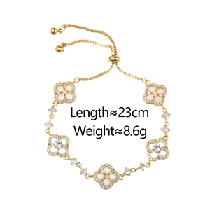 Adjustable gold clover bracelet with white shells, sparkling zircons and specs info