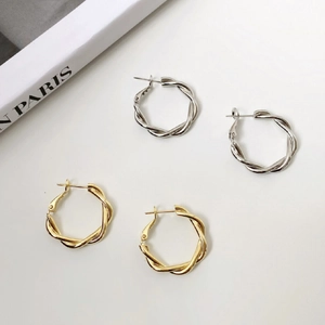 Minimalist geometric twisted hoop earrings in gold and silver plating with knot design