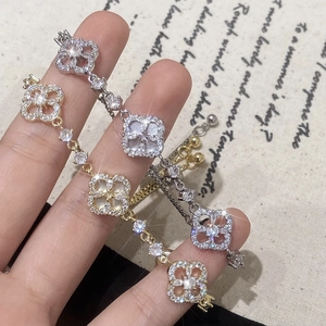 Adjustable gold and silver clover bracelets with zircon and shell inlay on burlap back