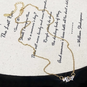 Exquisite 18K gold geometric zircon necklace with clear square pendant on poetic fabric