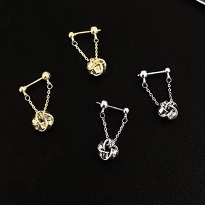 Gold and silver geometric spiral twist pendant tassel earrings on black background