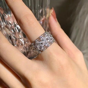 Gros plan d'une bague large argentée de luxe avec des motifs de fleurs en zircon