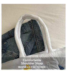 Close-up of comfortable quilted shoulder strap with romantic butterfly embroidery details