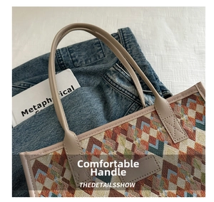 Detail of multi-color geometric weave pattern on canvas tote with faux leather trim