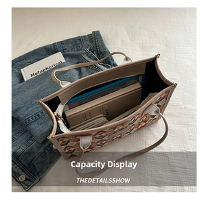 Interior detail of large capacity geometric tote bag showing space for books and wallet