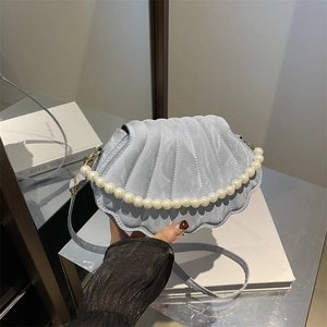 Stylish light blue shell-shaped handbag with pearl handle and textured finish