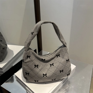 Quilted corduroy underarm bag with bow print and vintage rhombic stitching detail