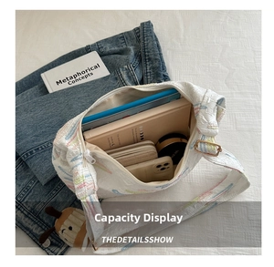 Interior view showing large capacity for tablet and wallet in white striped embroidery bag