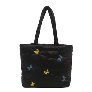 Black quilted tote bag with colorful butterfly embroidery and soft padded handles