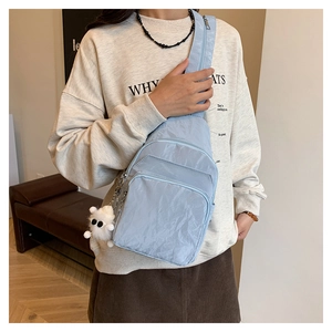 Versatile light blue nylon chest bag for women featuring stylish pleated texture and cute pendant