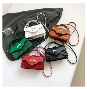 Top view of five colorful crocodile embossed crossbody bags with gold H-buckle hardware