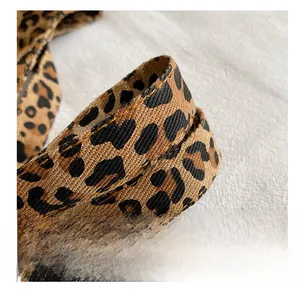 Close-up of durable leopard print shoulder strap with high-quality woven fabric texture