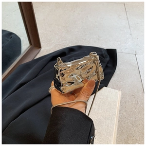 Mini metallic silver crossbody bag with liquid metal texture and delicate snake chain