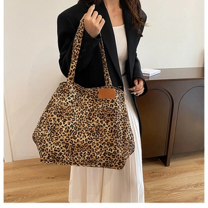 Leopard print canvas tote bag featuring large capacity and stylish front pocket detail