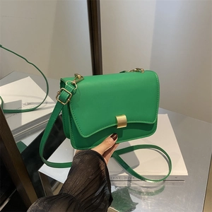 Minimalist green faux leather crossbody flap bag with gold metal buckle and strap