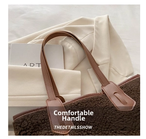 Detail showing high-quality stitching on brown faux leather handles of a plush tote bag