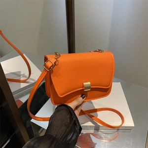 Orange PU leather crossbody bag with a gold metal clasp and adjustable shoulder strap