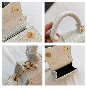 Detailed macro view of white woven texture and premium gold magnetic buckle on handbag
