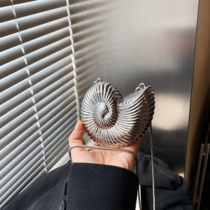 Unique silver nautilus shell crossbody bag with metallic spiral texture and chain strap