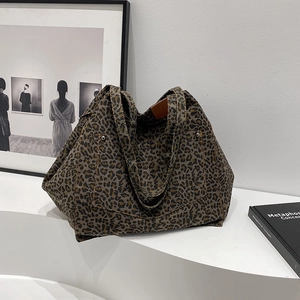 Leopard print canvas tote bag with large capacity and shoulder straps on art display
