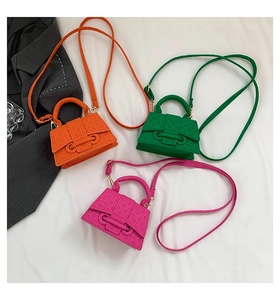 Detailed view of candy color mini crossbody bags with woven texture and lock buckle