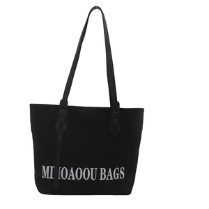 Minimalist black canvas tote bag with leather handles and white letter print for women