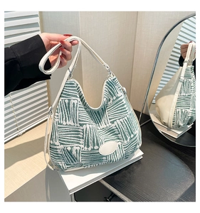 Vue détaillée du sac hobo en toile tissée avec motifs géométriques verts et cuir