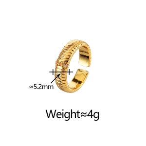 Macro detail of 5.2mm wide brushed gold ring with tiny zircon accents and ripple texture