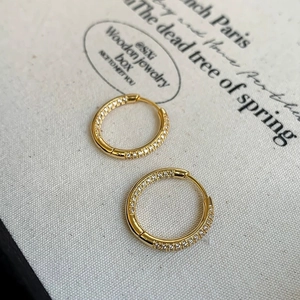 Detailed view of gold hoop earrings featuring micro-pave white zircon inlay for women