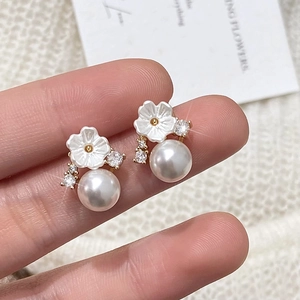 Elegant pearl earrings with shell flower design and sparkling diamond accents