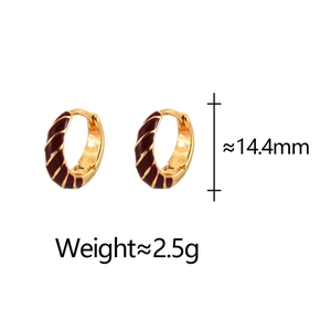 Detailed view of gold earrings with red spiral enamel, sized at 14.4mm and 2.5g