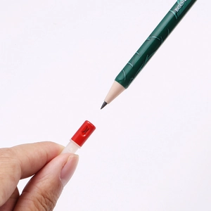 Detail showing a green eco-friendly pencil with a red and white plastic safety cap cover