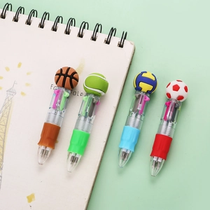 Detail of 4-pack sports ball topper multi-color pens on a notebook and green background