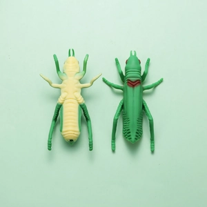 Detailed close-up of grasshopper-shaped ballpoint pen featuring realistic silicone textures