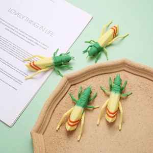 Detailed view of novelty grasshopper ballpoint pens with lifelike green silicone shell
