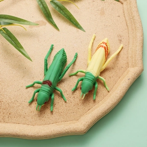 Detail of creative grasshopper shaped ballpoint pens with green silicone shell for students